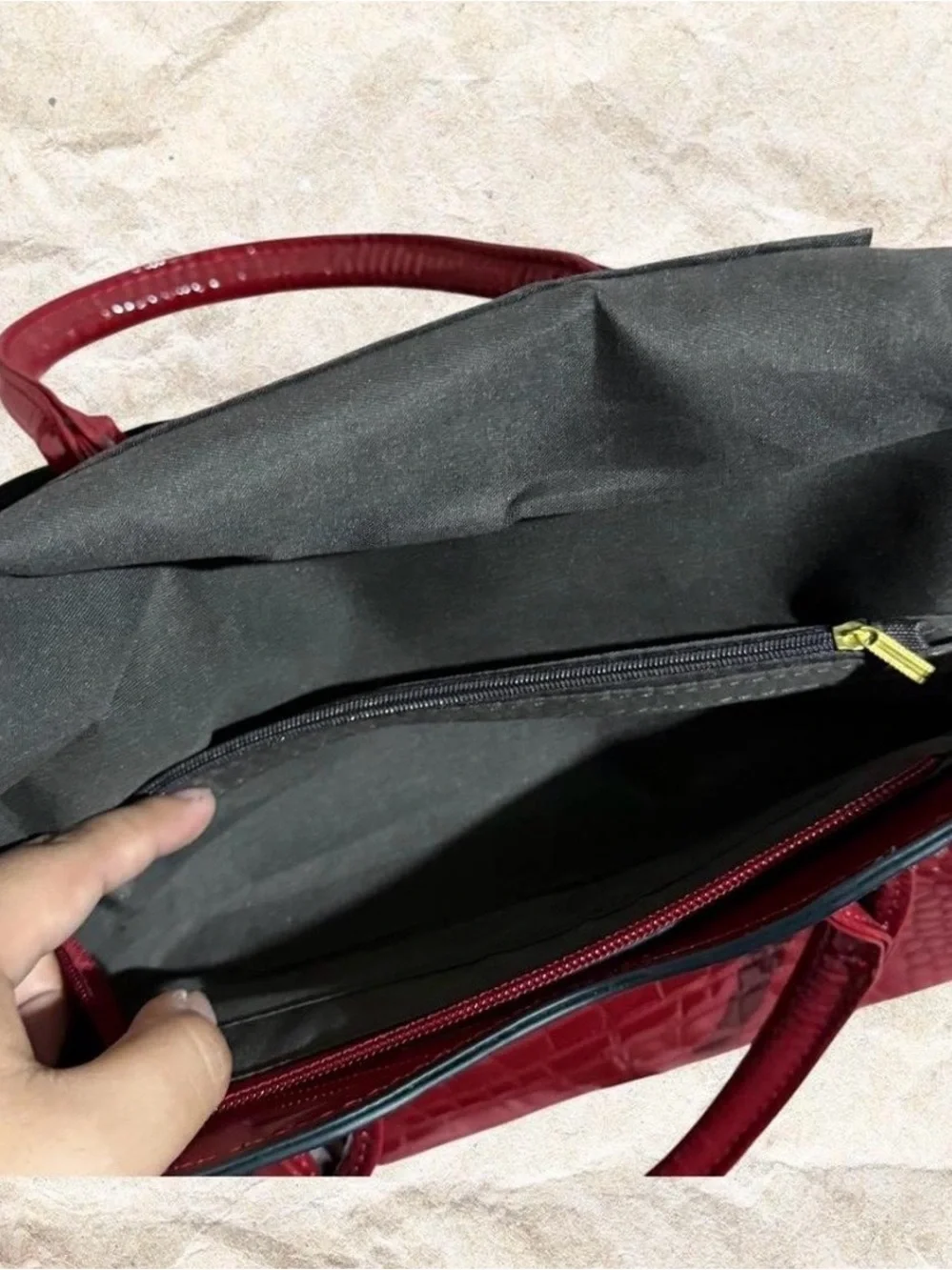 Red crocodile textured bow bag with gold hardware with removable strap